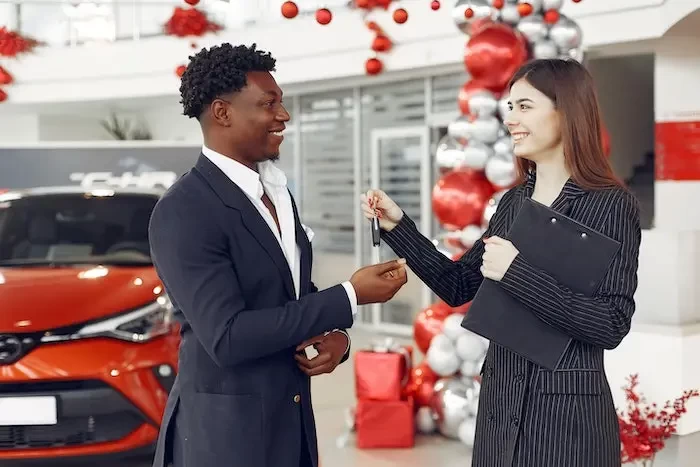  car dealer handing over the car keys small