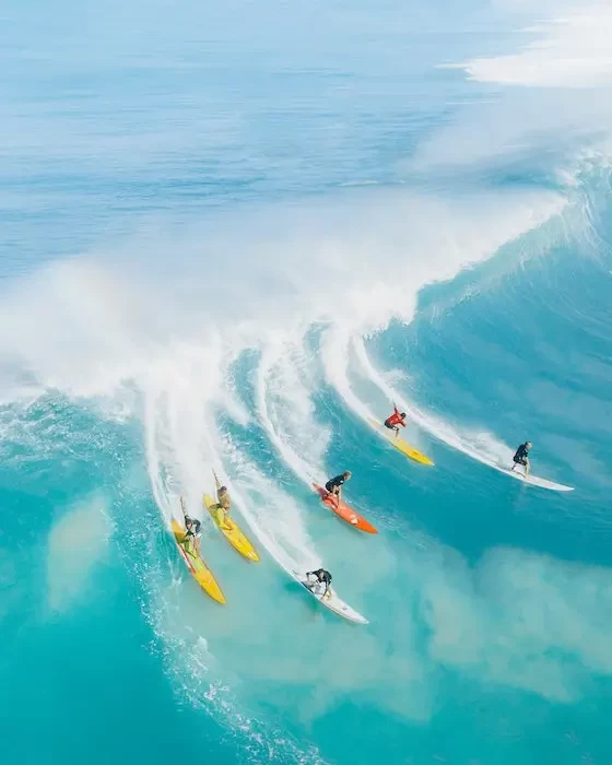  people surfing on sea waves small