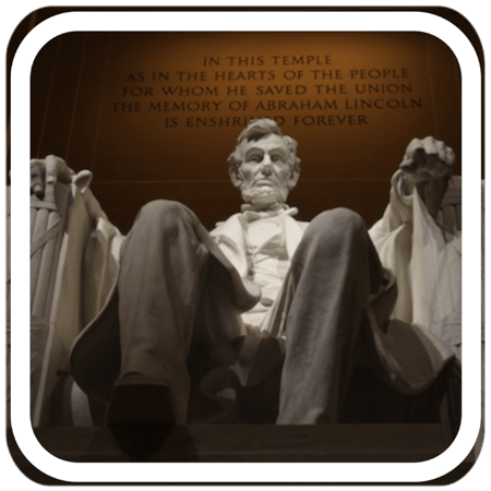 statue of Abraham Lincoln sitting in a stone carved chair  
