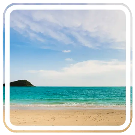 a beautiful beach with turquoise water and a small island in the distance