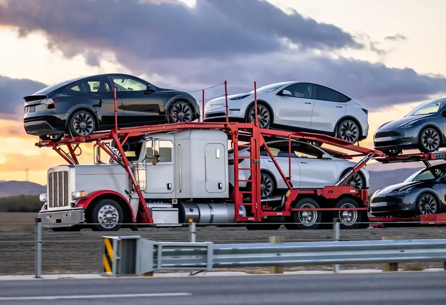 a semi truck carrying a bunch of cars on a two-tiered trailer