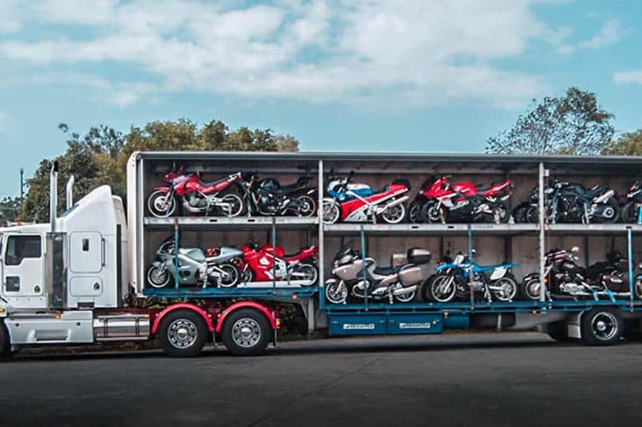 A semi-truck loaded with several motorcycles