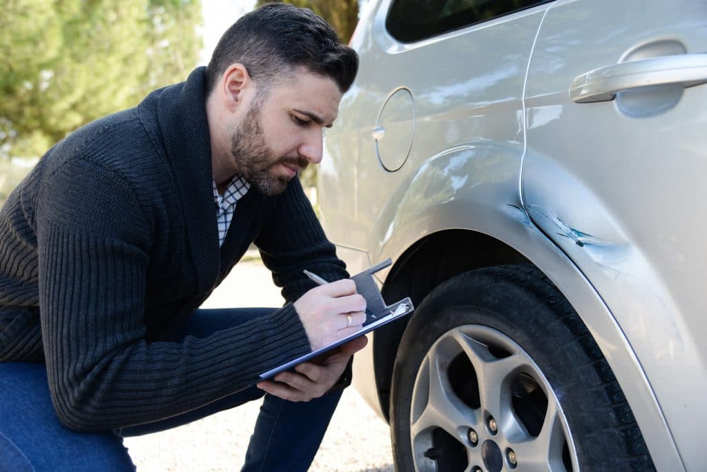 Employee helping customers with damage