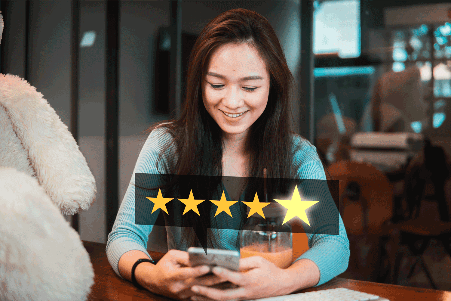 A woman is holding a phone, smiling, with a 5-star rating icon in front of her