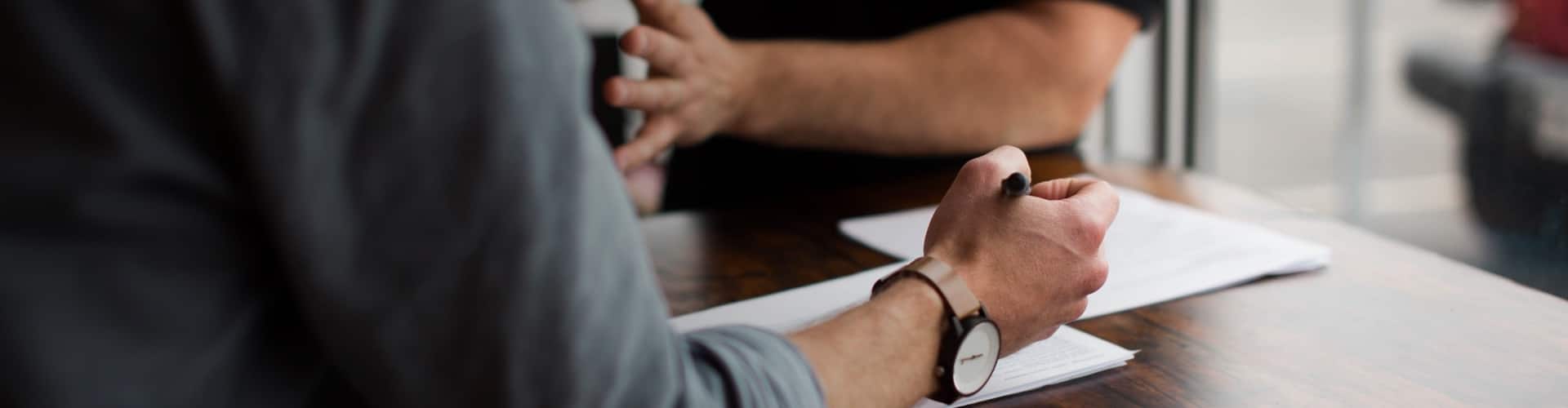 A person signing a paper document